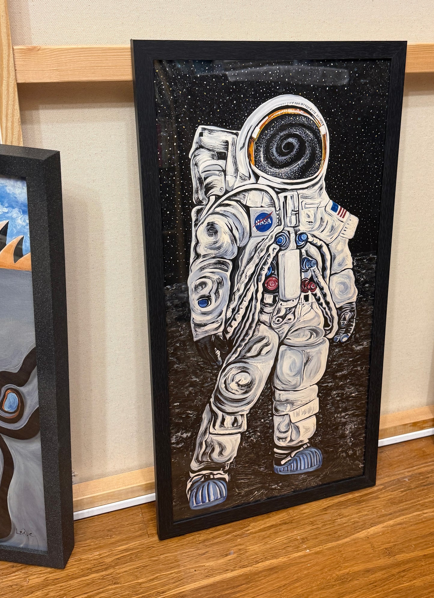 Quantum Astronaut 12x24 museum print in a black wood frame