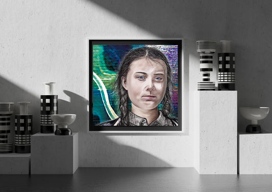 A framed portrait print of a young woman with braided hair, displayed on a textured gray wall in a styled interior setting with decorative vases and pedestal props. Greta Thunberg by Doug LaRue