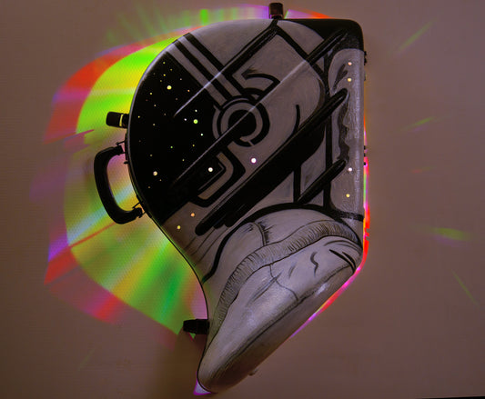 A hand-painted French horn case in the form of an astronauts helmet. Space Helmet with glowing LED party lights mounted inside to glow through hols in the helmet screen