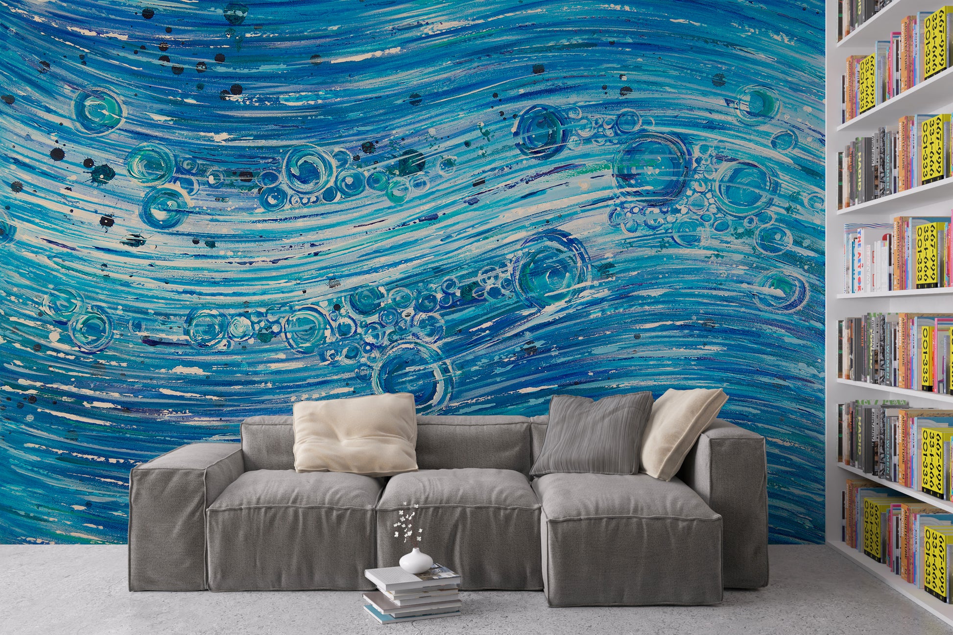 Gray sectional sofa in front of a blue abstract wall mural with a bookshelf to the right. 1420 Water Flow by Doug LaRue