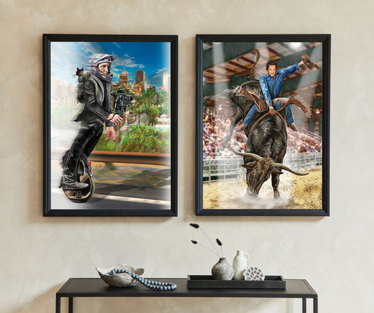 Two framed vertical art prints displayed side-by-side on a beige wall above a black console table. The left print shows a man in a black leather jacket riding a unicycle, set against a city skyline. The other riding a Longhorn bull. 1 Wheel Woody and Longhorn Bull Rider by Doug LaRue