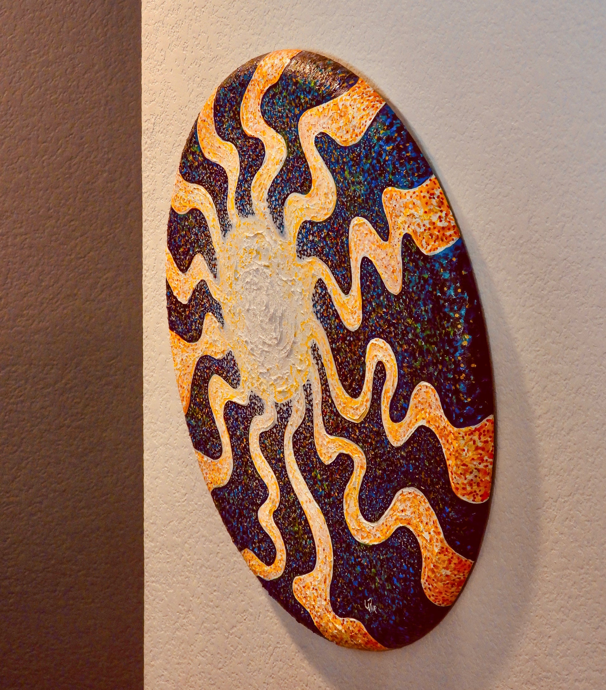 Sunburst by Doug LaRue on a wall in a stairway