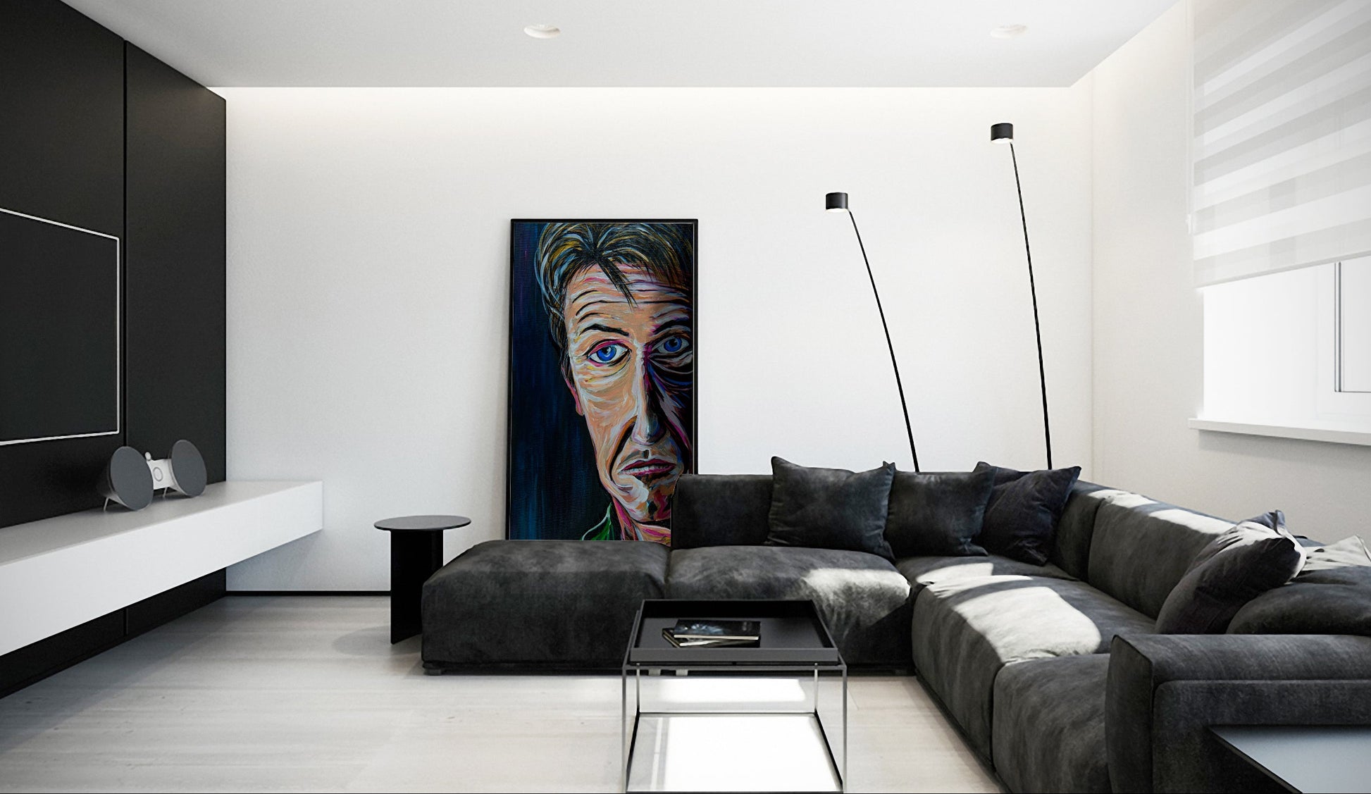Modern living room with a gray sectional sofa, coffee table, and wall art. Sean Penn Forlorn by Doug LaRue  leaning against the wall behind couch