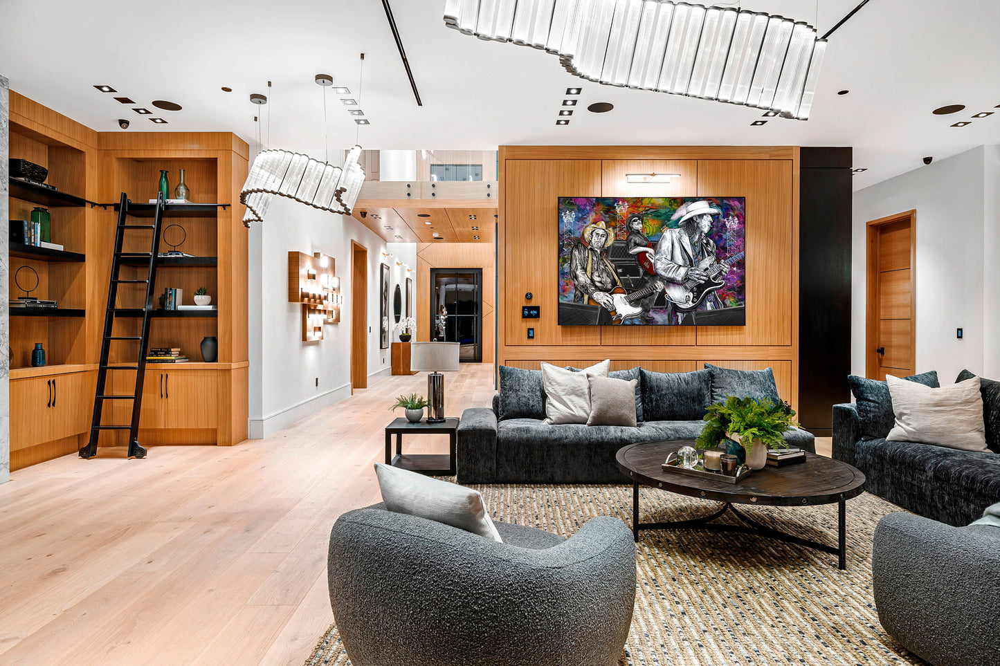 Modern living room with gray sofa, armchair, and decorative elements. Slim, Red and Stevie Ray by Doug LaRue