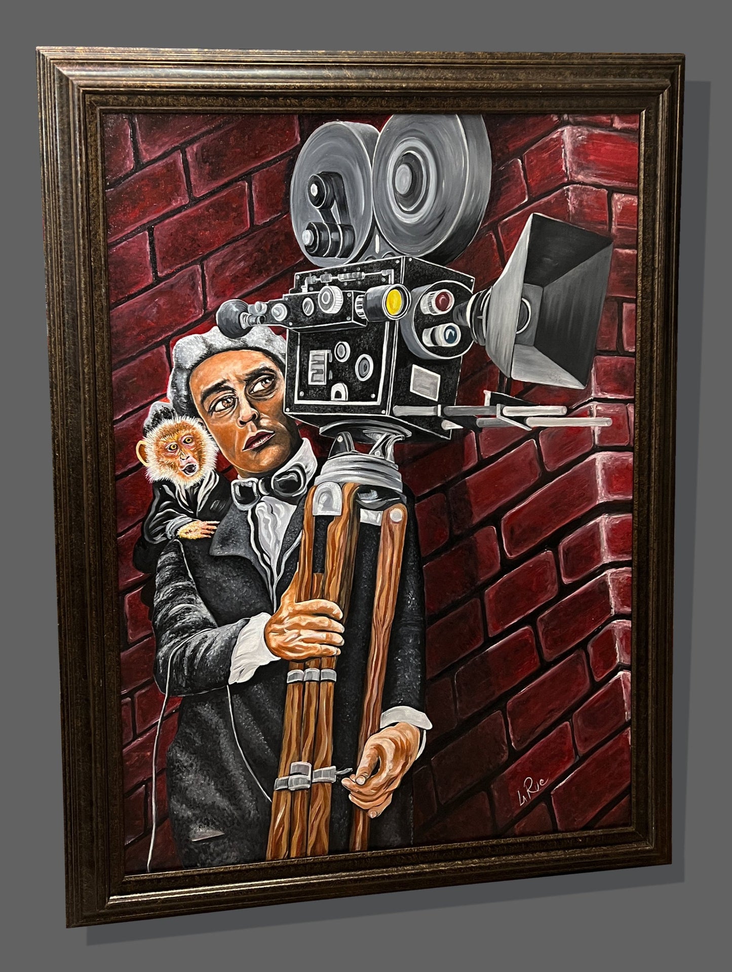 Buster Keaton • Camera Man oil panting in a classic bronze wood frame on a grey gallery wall.