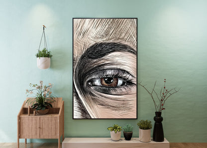 A framed vertical art print featuring a close-up pencil-style drawing of a human eye, displayed on a mint green wall above a light wood console table with small potted plants. Emma Gonzales detail by Doug LaRue