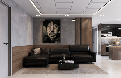 Modern living room with a black leather sofa, coffee table, and wall art. Jake pencil portrait done by Doug LaRue back at the University in 1985