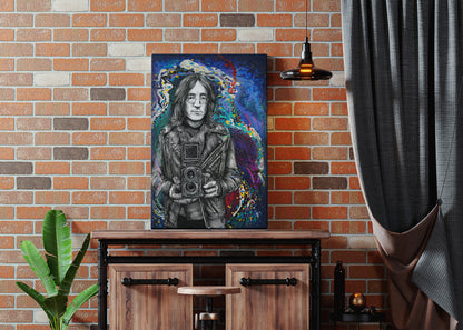 Artistic portrait of a person on a wall above a wooden cabinet with a plant and curtain in the foreground. John Lennon Twin Lens by Doug LaRue