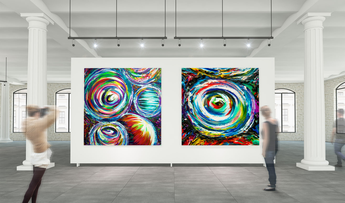 Colorful abstract art pieces on a white wall in a gallery setting with people walking by. Goggles and Quad Vortex by Doug LaRue
