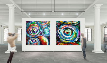 Colorful abstract art pieces on a white wall in a gallery setting with people walking by. Goggles and Quad Vortex by Doug LaRue